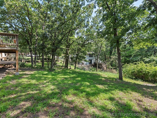 3321 Woodland Rd, Bartlesville, OK 74006 - view of grassy yard featuring a wooden deck