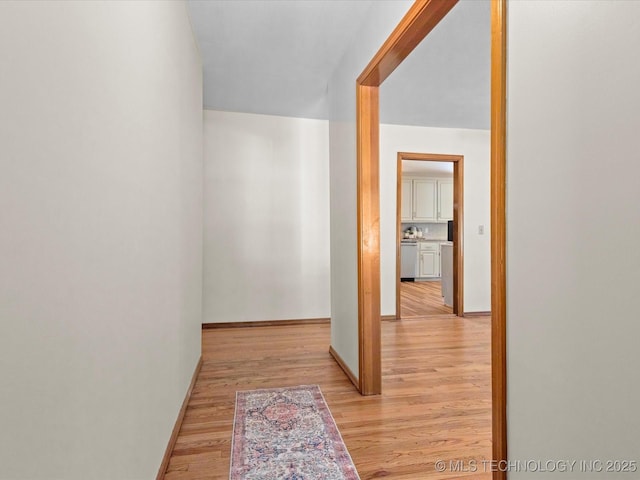 3321 Woodland Rd, Bartlesville, OK 74006 - corridor featuring light wood-type flooring and baseboards