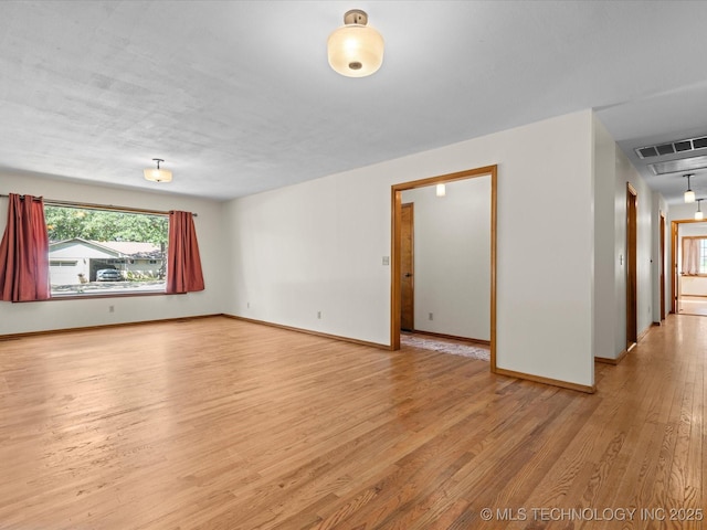 3321 Woodland Rd, Bartlesville, OK 74006 - spare room featuring light wood finished floors and baseboards