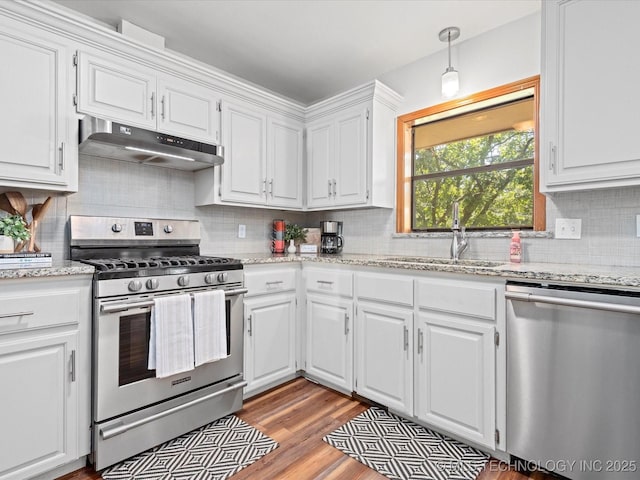 3321 Woodland Rd, Bartlesville, OK 74006 - kitchen featuring stainless steel appliances, under cabinet range hood, and white cabinetry