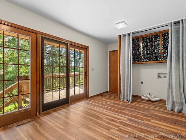 3321 Woodland Rd, Bartlesville, OK 74006 - doorway to outside featuring light wood-type flooring and baseboards