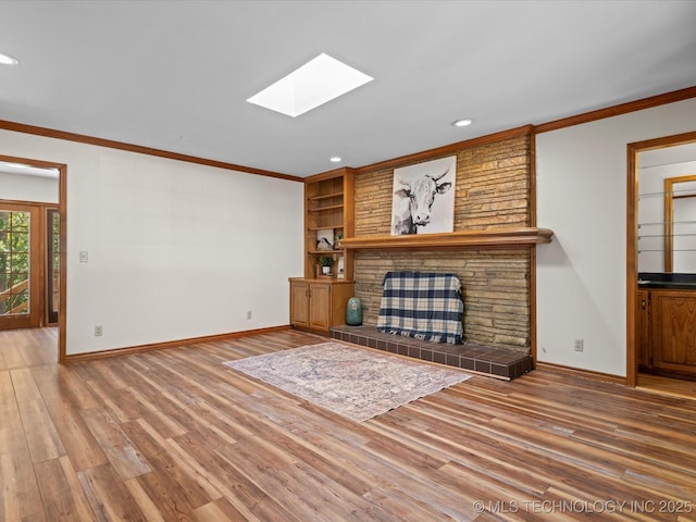 3321 Woodland Rd, Bartlesville, OK 74006 - unfurnished living room featuring a skylight, crown molding, wood finished floors, recessed lighting, and built in features