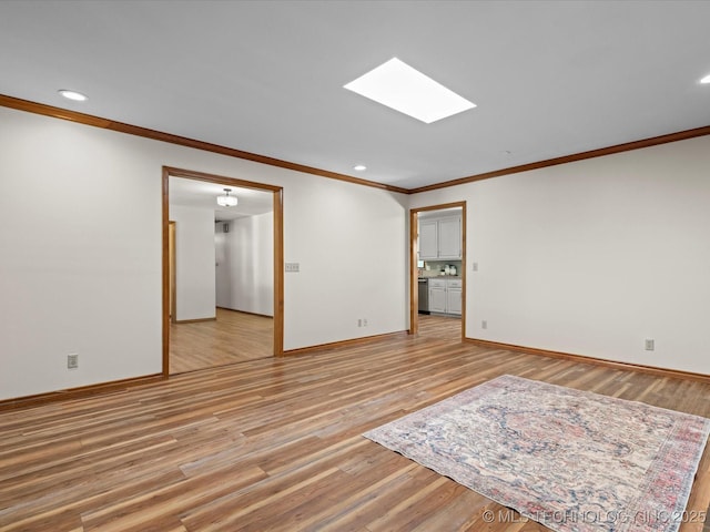 3321 Woodland Rd, Bartlesville, OK 74006 - empty room with crown molding, light wood finished floors, a skylight, and recessed lighting