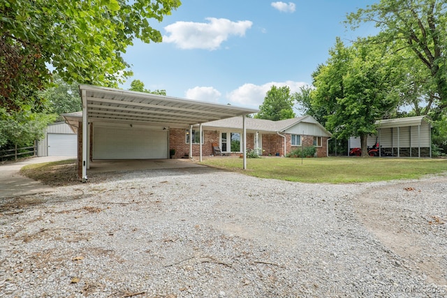 13201 W 86th St S, Sapulpa, OK 74066 - view of front of home featuring a front yard, brick siding, driveway, and an outdoor structure