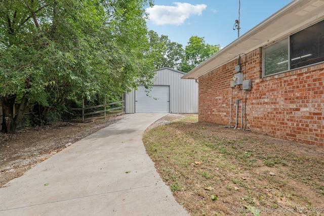 13201 W 86th St S, Sapulpa, OK 74066 - view of home's exterior featuring driveway, an outdoor structure, brick siding, and a garage