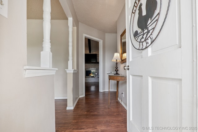 13201 W 86th St S, Sapulpa, OK 74066 - entrance foyer with a fireplace, wood finished floors, and a textured ceiling
