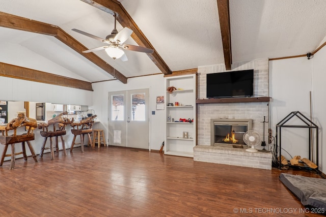 13201 W 86th St S, Sapulpa, OK 74066 - living room with wood finished floors, ceiling fan, a brick fireplace, and a textured ceiling