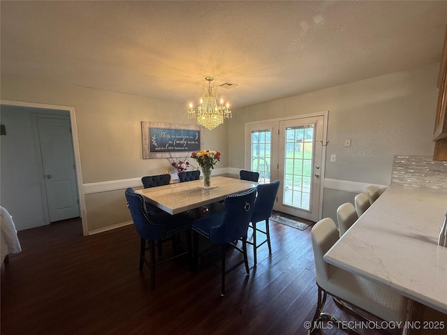 4001 Chaucer, Muskogee, OK 74403 - dining area with dark wood-type flooring, a chandelier, wainscoting, and a textured ceiling