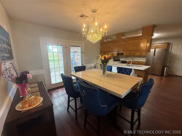 4001 Chaucer, Muskogee, OK 74403 - dining space featuring a chandelier and dark wood-type flooring