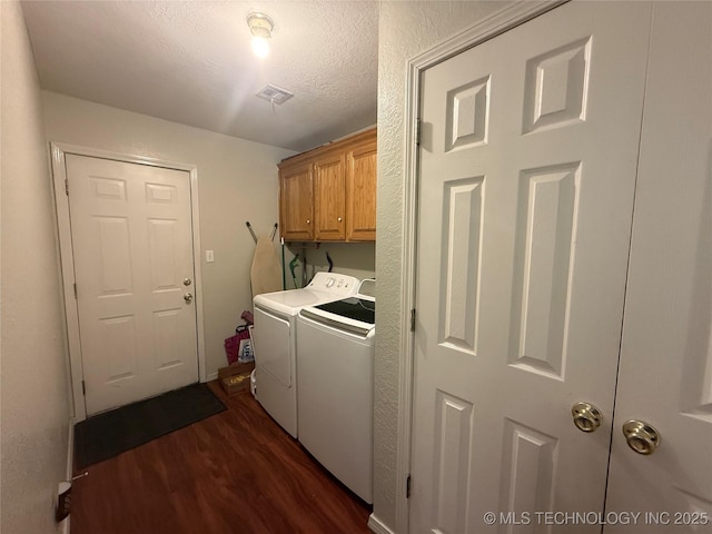 4001 Chaucer, Muskogee, OK 74403 - laundry area featuring washer and clothes dryer, dark wood finished floors, cabinet space, and a textured ceiling