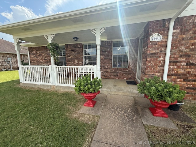4001 Chaucer, Muskogee, OK 74403 - property entrance featuring covered porch, brick siding, and a yard