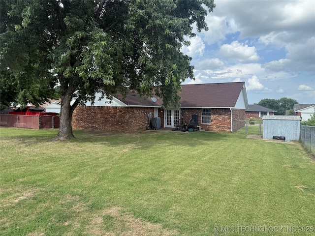 4001 Chaucer, Muskogee, OK 74403 - rear view of house featuring a fenced backyard, brick siding, and french doors