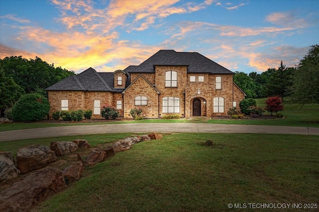 3892 Folsom Rd, Durant, OK 74701 - french country inspired facade featuring a lawn, curved driveway, and roof with shingles