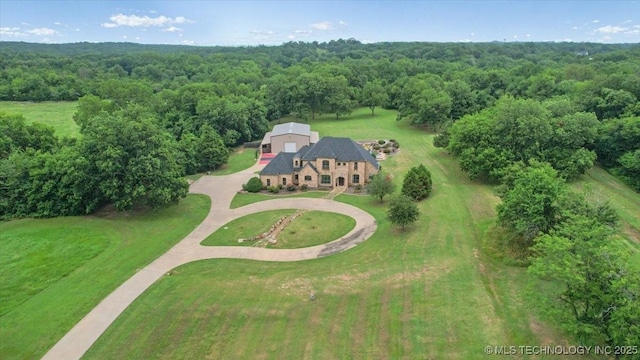 3892 Folsom Rd, Durant, OK 74701 - aerial view of property and surrounding area with a heavily wooded area