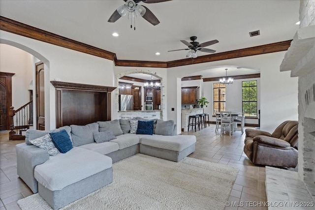 3892 Folsom Rd, Durant, OK 74701 - living room with a chandelier, arched walkways, a ceiling fan, ornamental molding, and recessed lighting