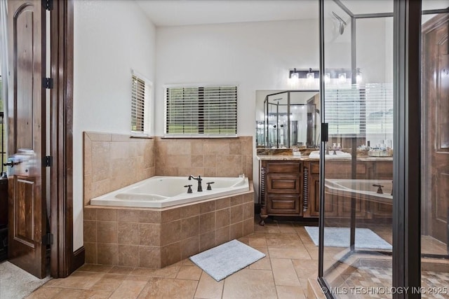 3892 Folsom Rd, Durant, OK 74701 - bathroom with vanity, a garden tub, and stone tile flooring