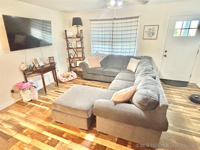 1105 NW 9th St, Stigler, OK 74462 - living room featuring wood finished floors and a ceiling fan