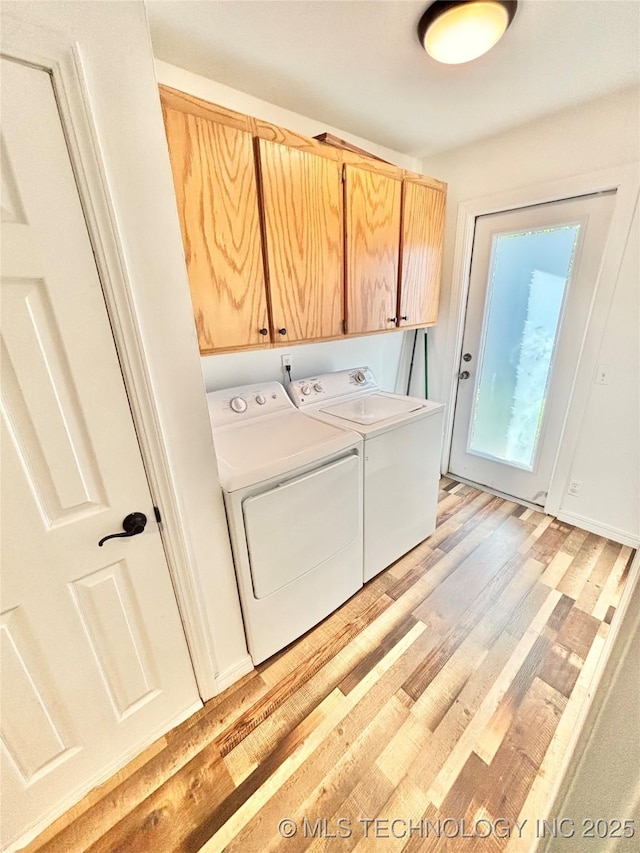 1105 NW 9th St, Stigler, OK 74462 - washroom featuring cabinet space, separate washer and dryer, and light wood-type flooring