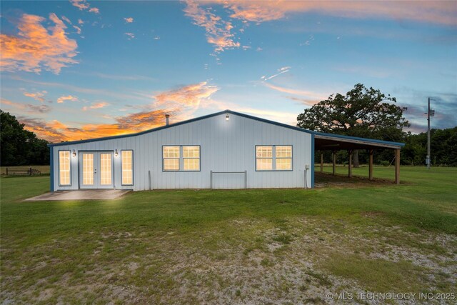 17652 S Hickory St, Sapulpa, OK 74066 - back of house at dusk featuring french doors, a yard, and an attached carport