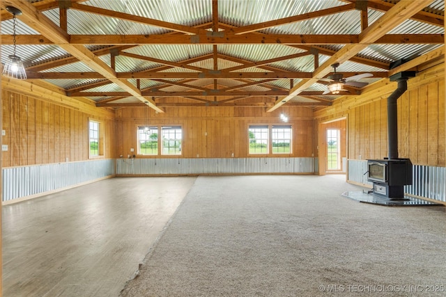 17652 S Hickory St, Sapulpa, OK 74066 - unfurnished living room featuring a wood stove, a ceiling fan, wood finished floors, plenty of natural light, and vaulted ceiling