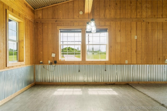 17652 S Hickory St, Sapulpa, OK 74066 - empty room with light wood-style flooring, healthy amount of natural light, vaulted ceiling, and wooden walls
