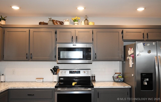 401 N Ash St, Sallisaw, OK 74955 - kitchen featuring stainless steel appliances, tasteful backsplash, and gray cabinetry