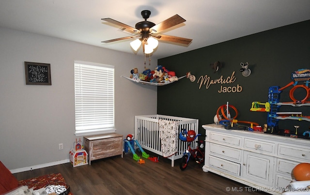 401 N Ash St, Sallisaw, OK 74955 - bedroom with a nursery area, wood finished floors, multiple windows, and ceiling fan