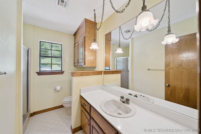 19585 Cottrell Dr, Claremore, OK 74019 - bathroom with vanity, a stall shower, a textured ceiling, and tile patterned floors