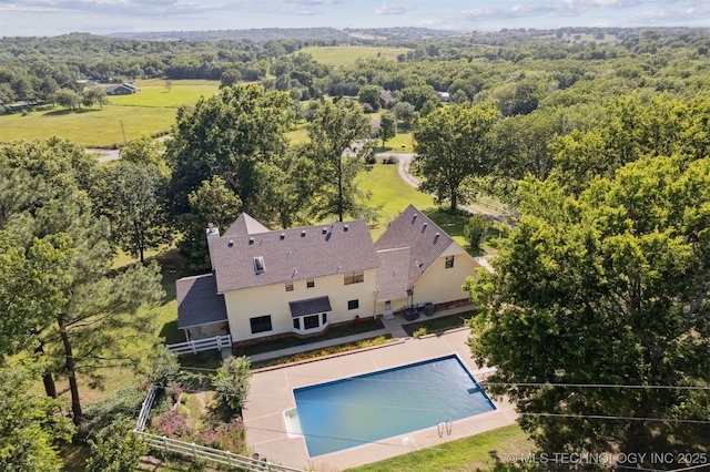 19585 Cottrell Dr, Claremore, OK 74019 - view of subject property with a pool and a heavily wooded area