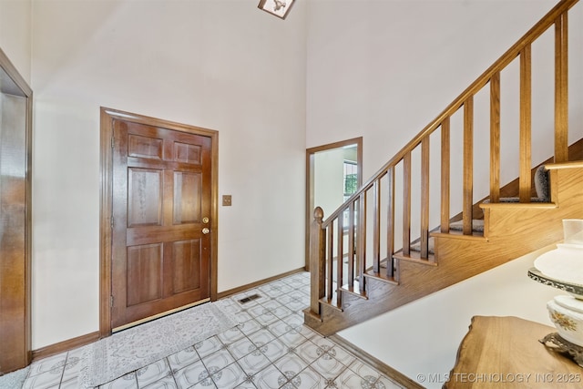 19585 Cottrell Dr, Claremore, OK 74019 - entryway with a high ceiling, stairs, and tile patterned floors