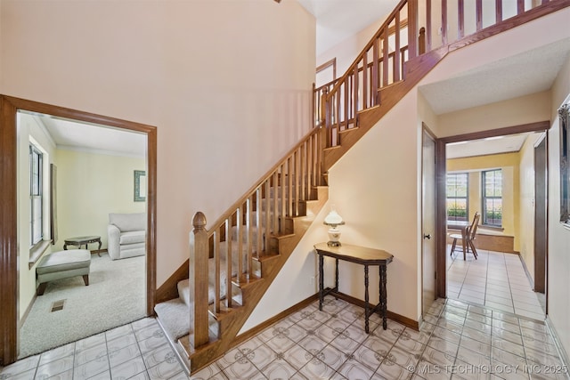 19585 Cottrell Dr, Claremore, OK 74019 - stairs featuring baseboards and a towering ceiling
