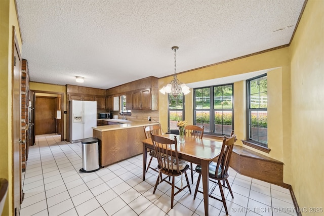 19585 Cottrell Dr, Claremore, OK 74019 - dining area with a textured ceiling, a chandelier, and light tile patterned flooring