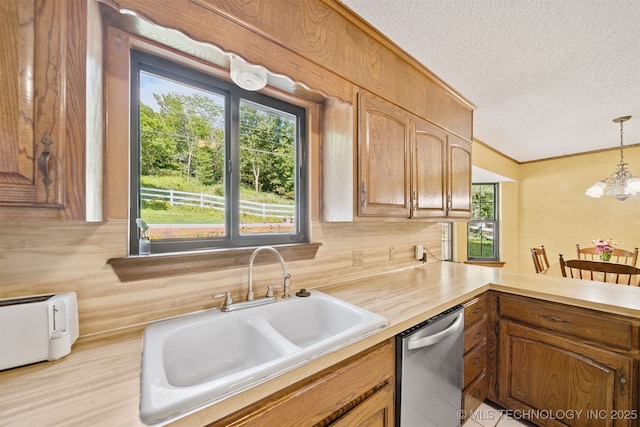 19585 Cottrell Dr, Claremore, OK 74019 - kitchen with stainless steel dishwasher, a textured ceiling, healthy amount of natural light, and light countertops