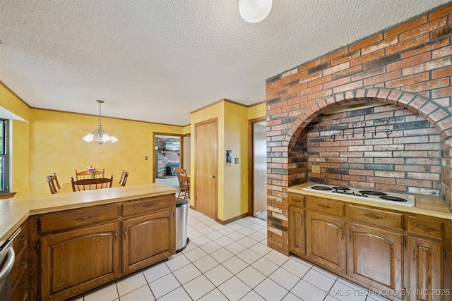 19585 Cottrell Dr, Claremore, OK 74019 - kitchen with white electric stovetop, light countertops, a textured ceiling, pendant lighting, and light tile patterned floors