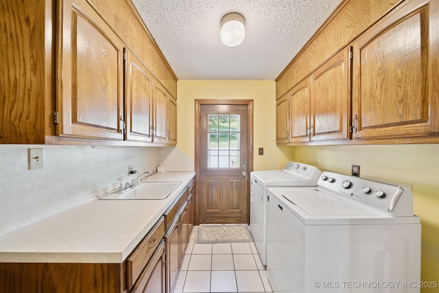 19585 Cottrell Dr, Claremore, OK 74019 - laundry room featuring cabinet space, washer and dryer, a textured ceiling, and light tile patterned floors