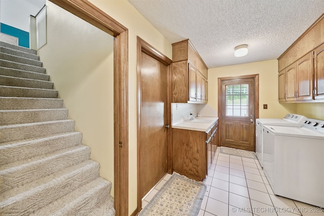 19585 Cottrell Dr, Claremore, OK 74019 - washroom with cabinet space, independent washer and dryer, light tile patterned floors, and a textured ceiling
