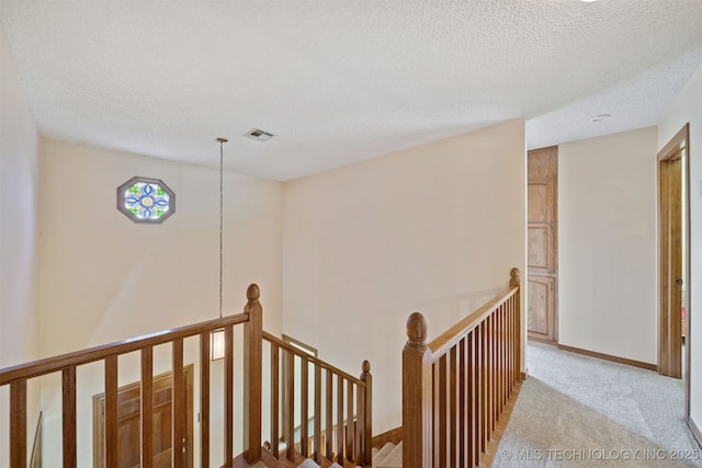 19585 Cottrell Dr, Claremore, OK 74019 - hall featuring an upstairs landing, carpet flooring, and a textured ceiling