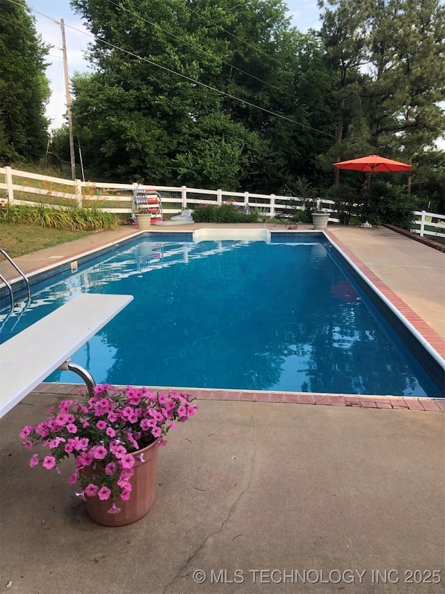 19585 Cottrell Dr, Claremore, OK 74019 - view of swimming pool featuring a diving board and a patio