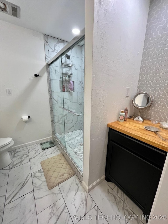2807 Irving St, Muskogee, OK 74403 - full bathroom featuring marble look tile flooring, a stall shower, and vanity