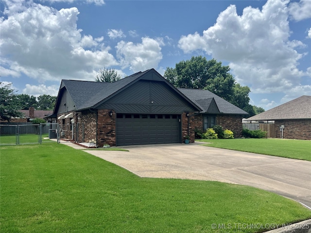 2807 Irving St, Muskogee, OK 74403 - view of front of property featuring a gate, an attached garage, concrete driveway, brick siding, and a shingled roof