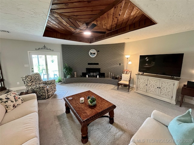 2807 Irving St, Muskogee, OK 74403 - carpeted living area featuring ceiling fan, wooden ceiling, and a brick fireplace