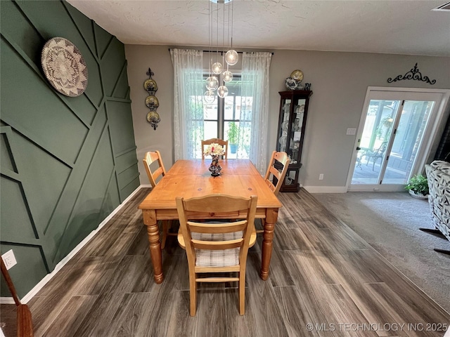 2807 Irving St, Muskogee, OK 74403 - dining area featuring healthy amount of natural light, dark wood-style flooring, a chandelier, and a textured ceiling