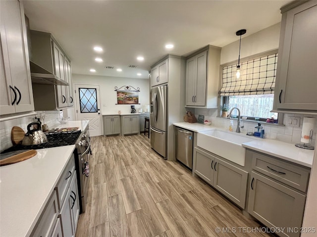 2807 Irving St, Muskogee, OK 74403 - kitchen featuring appliances with stainless steel finishes, gray cabinets, backsplash, light countertops, and recessed lighting