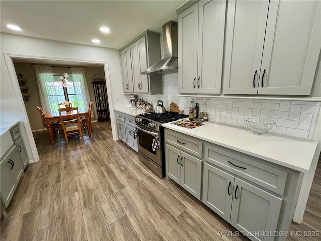 2807 Irving St, Muskogee, OK 74403 - kitchen featuring gas stove, wall chimney exhaust hood, tasteful backsplash, gray cabinetry, and recessed lighting
