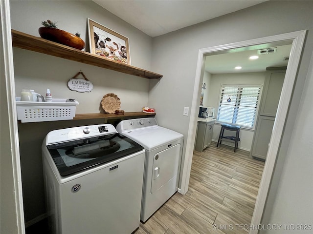 2807 Irving St, Muskogee, OK 74403 - laundry area with washing machine and dryer and light wood-style flooring