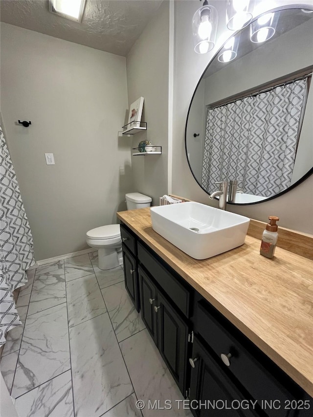 2807 Irving St, Muskogee, OK 74403 - full bathroom with vanity, marble finish flooring, and a textured ceiling