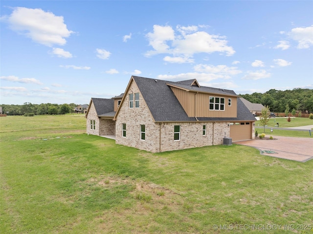 684 Chateau Bnd, Ardmore, OK 73401 - view of home's exterior featuring concrete driveway, a yard, brick siding, and board and batten siding