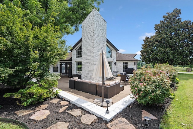 56901 E Walnut, Monkey Island, OK 74331 - rear view of house with an outdoor living space, a patio, a chimney, and stone siding