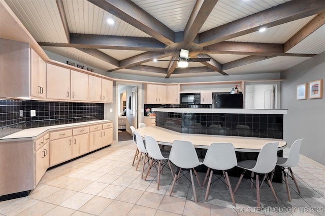 56901 E Walnut, Monkey Island, OK 74331 - kitchen featuring refrigerator, black microwave, backsplash, beamed ceiling, and light tile patterned floors