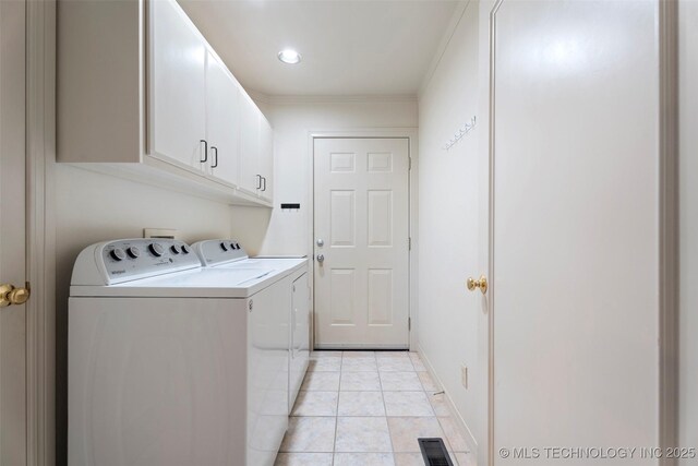 56901 E Walnut, Monkey Island, OK 74331 - washroom featuring washer and dryer, cabinet space, ornamental molding, and light tile patterned floors